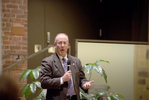 Winona State’s new vice president of advancement and executive director of the Winona State Foundation, Ron Dempsey, speaks at his advancement reception Thursday, Jan. 28. (Photo by Jacob Striker)