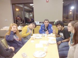Students pose and converse at a Conversation Partners event. The event aims to connect international students with American English speakers to build relationships and strengthen English speaking for international students. (Contributed photo)