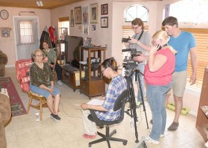 Professor of Diné College Miranda Haskie watches Winona State senior Ben Strand and alumni Jordan Gerard, and Dine College students Brandon Tayah and Skylar Ogren interview Peggy Scott during the last year of the Navajo Oral History Project. (Contributed photo)