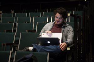 Kort Lindblad stage manages his senior capstone project in the Black Box Theatre of the Performing Arts Center Monday evening. Lindblad wrote, produced and stage managed his own work, “Morning, Noon & Night.” (Photo by Taylor Nyman)