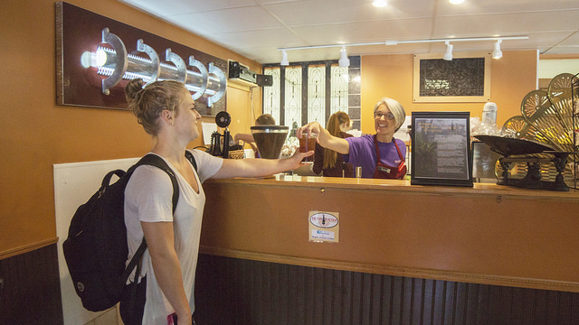 Kate Simonet, a Winona State student, grabs a coffee at Mugby Junction. (Photo by Susan Torkelson)