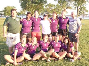 Winona State women’s rugby won its first Annual Lakefront 7s division title on June 27. Players from left to right, back row: Lanoira Duhart, Megan Wolff, Rachel Thompson, Lachen Esters, Holly Edelburg. Players from left to right, front row: Andrea White, Samantha Wilcox, Katie Dries, Lindsey Bucki, Kalene Hill. Head coach Josh Krzewinski on right. (Contributed photo)
