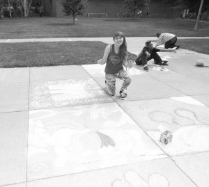 First-year Megan Moore poses with her drawing of a nine-tailed fox. (Photo by Emma Masiulewicz) 
