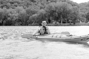 Junior Nikko Aries kayaks down the water. (Photo by Sarah Murray)