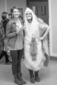  Senior Claire Arvidson dresses in a vagina costume to promote FORGE, as senior Kim Schneider donates tampons. (Photo by Taylor Nyman)