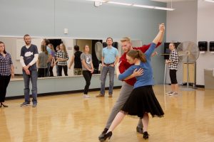 Senior Emily Thorpe and junior Tim Johnson demonstrate a dance for the ballroom dance club. (Photo by Madison Bowe)