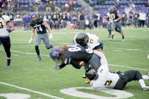 
Dylan Ulferts gets tackled by a pair of Wayne State defenders Saturday in Winona. (Photo by Jacob Striker)