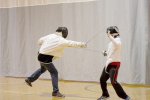 Senior Drew Peterson and junior Lance Urbick start off the first week of school with fencing practice. (Photo by Madison Bowe)