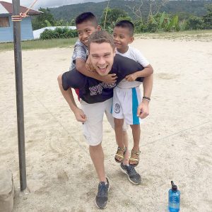Trevor Frosig plays with children on his trip to Ecuador with the MedLife Club. (Contributed photo)