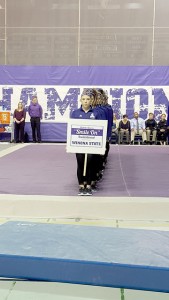 Winona State University and the other three teams present at Friday’s Brooke Baures “Smile On” Memorial Invite honored Baures’ memory to open the meet. (Photo by Allison Mueller)