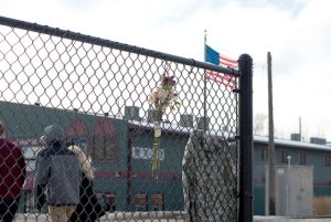 Flowers and 25-year-old student veteran Derek Bute’s jacket have been placed at the Huff Street train crossing to honor his memory after he was fatally hit by a train Sunday, Jan. 17. (Photo by Jacob Striker)