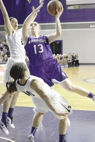Senior guard Alexis Foley attempts a left-handed layup against Concordia-St. Paul University Friday in Winona. The Warriors defeated the Mavericks 73-60. (Photo by Emma Masuilewicz)
