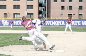 Sophomore Taylor Field beats the throw to first base against Minnesota Duluth Sunday in Winona. The Warriors beat the Bulldogs 14-3 and 13-4. (Photo by Jacob Striker)