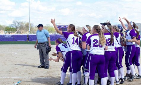 Winona State University softball team cheers on sophomore Jamee Schleis after she hit a grand slam during their first game Thursday against Augustana University. The Warriors won 11-1 followed by 3-0 victory later in the day. (Photo by Brianna Murphy)