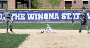 Winona State University sophomore Joe Kubera dives for second on a steal during a game Thursday, April 21 against Augustana University at Loughrey Field in Winona. (Photo by Jacob Striker)