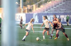 Winona’s Kendyl Keay (left) and Malia Durr (right) attempt to score against University of Wisconsin-La Crosse during a home scrimmage at Altra Federal Credit Union Stadium on Thursday, Aug. 25. (Photo by Jacob Striker)