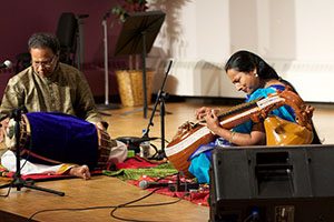 Nirmala Rajasekar (right) and Shri Thanjavur Murugaboopathi (left) perform in the Performing Arts Center as part two of the Winona State International Music Series on Thursday. Together, they introduced the audience to carnatic music, a type of music from South India. (Photo by Brianna Murphy)