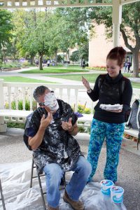 Ethan Krause, Winona State English professor, enjoys a serving of pie during the “Pie in the Face Fundraiser” on Wednesday, Oct. 5.
