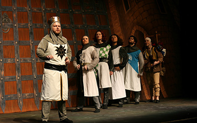 Winona State alumnus Thomas Sonneman plays the role of King Arthur and introduces his Knights of the Round Table in “Spamalot” during the last dress rehearsal Tuesday, Oct. 18. (By Lauren Reuteler)