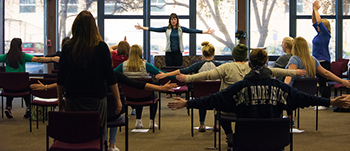 Instructor Sarah Super leads a trauma-sensitive yoga class in the Tau Center on Tuesday, Nov. 1. Super has become a certified trauma-sensitive yoga instructor, and is also an activist for survivors of sexual violence. (Photo by Nikko Aries)