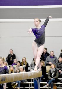 First-year Elizabeth Maher performs her beam routine during a meet against Gustavus Adolphus College in Winona State’s McCown Gymnasium on Friday, Jan. 13. (Photo by Allison Mueller)
