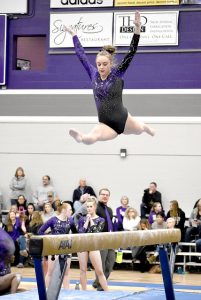 Sophomore Natalie Koehler competes on the beam during Friday’s meet, which resulted in a Winona State victory 184.150-182.400. (Photo by Allison Mueller)