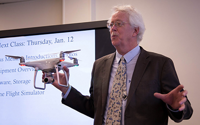 Professor Tom Grier shows the new DJI Phantom 4 Pro drone purchased by Winona State to students of the aerial visual communications course on Tuesday, Jan. 10 in Phelps Hall. (Photo by Taylor Nyman)