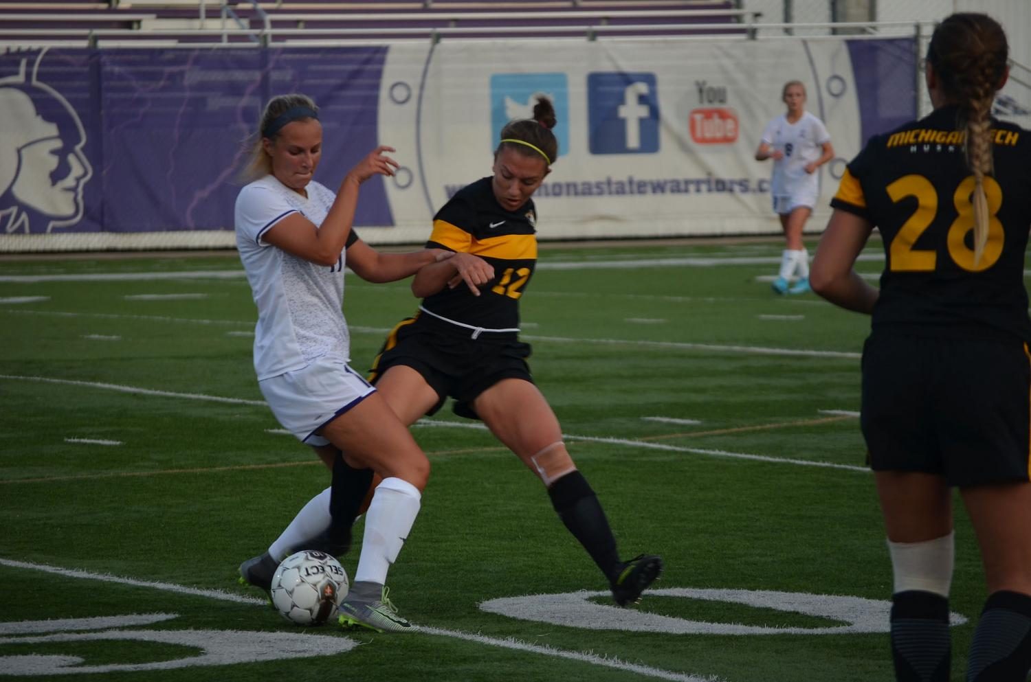 Senior midfielder Mikaella Sabinash fights for control of the ball against Michigan Technological University on Friday night at Altra Federal Credit Union Stadium. The Warriors lost 1-0 on Friday but went on to win Sunday afternoon against Northern Michigan University. 