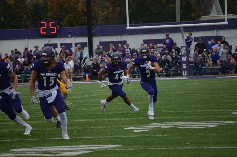 Sophomore Jake Balliu runs down the field towards the end zone on Saturday, Oct. 21s game against Wayne State College in Altra Credit Federal Union Stadium.


