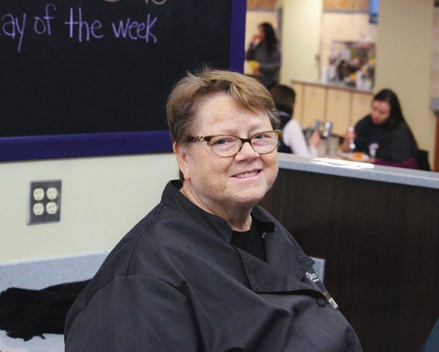 Sandy Rothering sits at the cash register of the Jack Kane Dining Center in Kryzsko Commons. Rothering has worked at Winona State since 2001, and has been working the Jack Kane cash register for the past nine years.