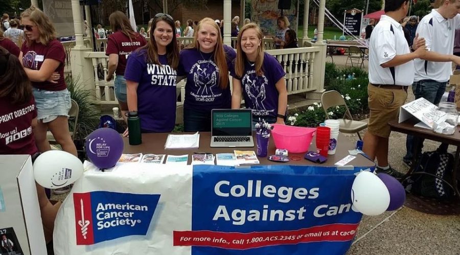 Left to right: Alex Strelow, Eve Hlavka and Sydney Mohr promote Colleges Against Cancer at the Club Fair during orientation week.  As a subdivision of the American Cancer Society the club’s goal is to raise awareness and help fundraise for different events.