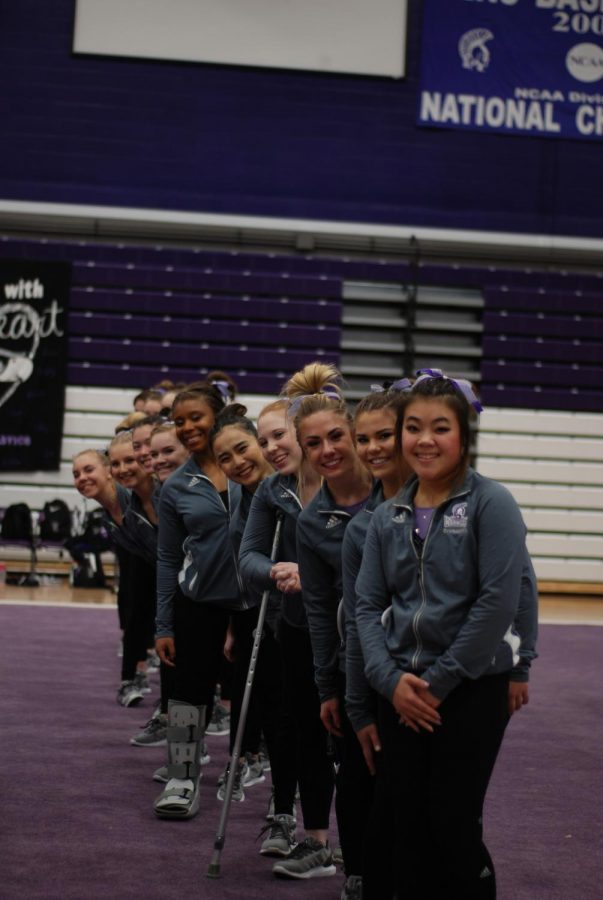 The Winona State Gymnastics Team lines up at the start of a dual meet against Hamline University and the University of Wisconsin Whitewater last Friday in McCown Gymnasium. This meet was also senior night where the team honored seniors Eboni Jackson, Katie Pipp, Gianna Scala, Katie Carling and Emily Woitchek. 