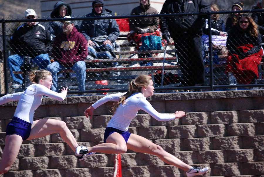 Left to right: Sophomore Kacey Davit and Senior Olivia Fixsen leap over hurdles during the Dingels/Brueggen Open on Thursday, March 29 at Saint Mary’s University where the Warriors claimed eight first-place finishes.  