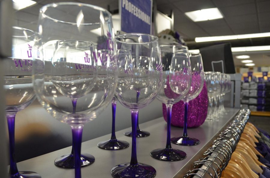 Winona State University wine glasses are set on in the Winona State bookstore. Winona State, which is a dry campus, sells multiple drinkware items which are typically used for alcoholic beverages.