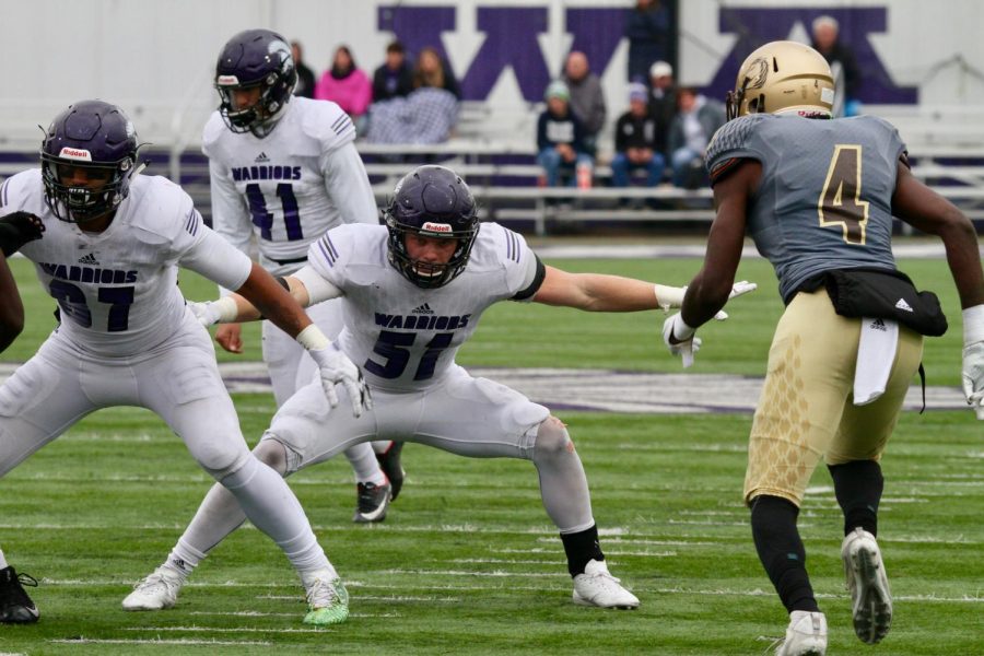 Sophomore Carter Duxbury and first-year Jaylen Schleicher block the defense from Southwest Minnesota State University on Saturday, Oct. 27 at Altra Credit Federal Union Stadium. The Warriors won 38-26.  