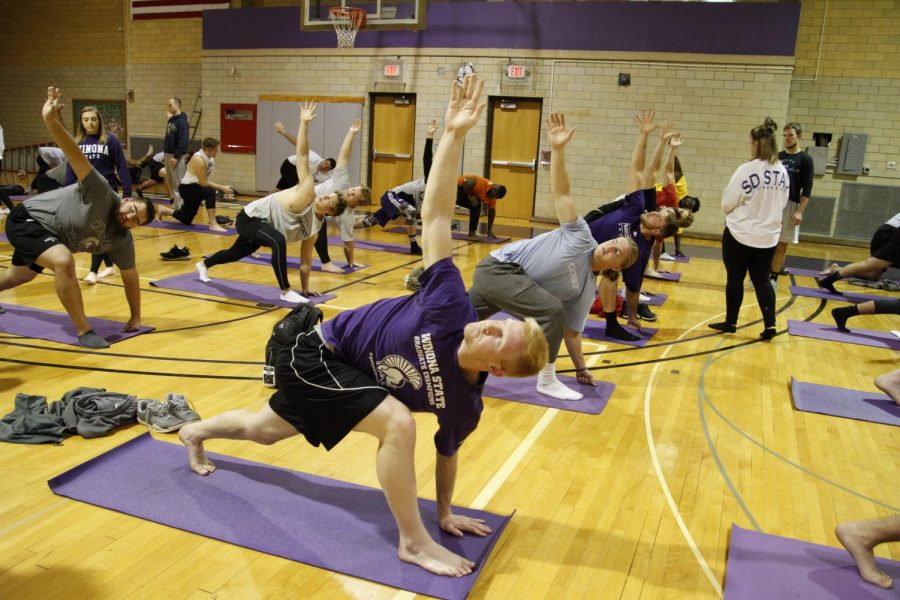 Members of the Winona State football team participate in the Restorative Flow Movement Pattern program which was designed to help athletes recover from hard practices or injuries.