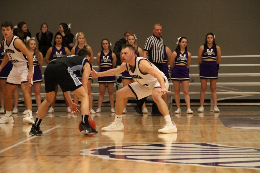 Senior, Mason Domask guards a player from Upper Iowas Unviersity during Saturdays game at McCown Gymnasium, where the Warriors were victorious with a final score of 72-50. 