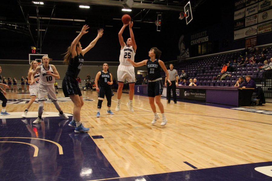Senior Kayla Shaefer makes a jump shot while being covered by three players from Upper Iowa University during Saturday, Dec. 1’s game in McCown Gymnasium. The Warriors finished the game with a winning score of 74-48 bringing their season record to three wins and two losses.  