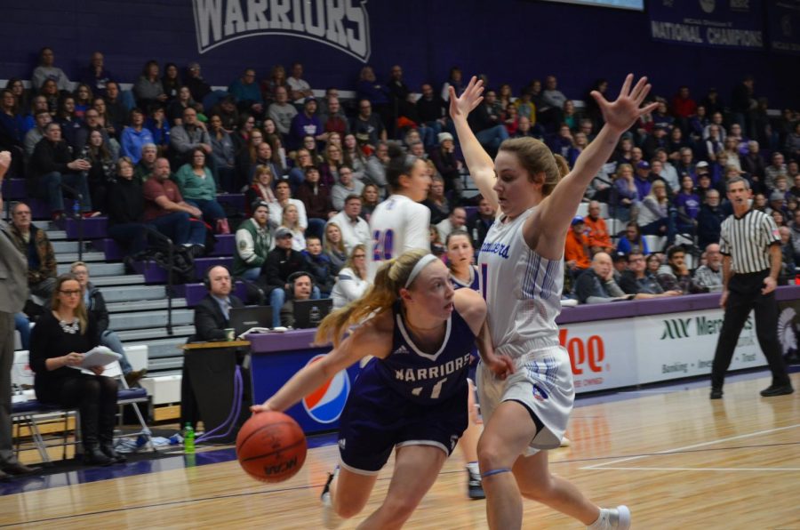 Sophomore Emily Kieck weaves around a University of Mary player on Saturday, February 9 in McCown Gymnasium. The Warriors took home two wins, scoring 84-46 on Friday and 57-54 on Saturday.  