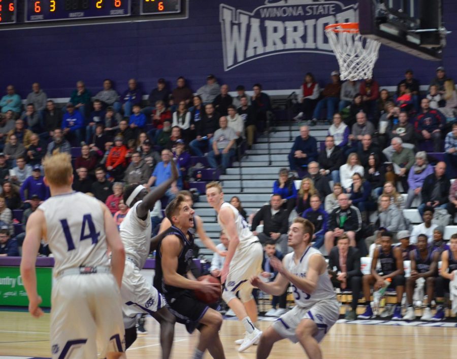 Junior guard Caleb Wagner charges toward the net in an attempt on basket during a game against the University of Sioux Falls in McCown Gymnasium. 