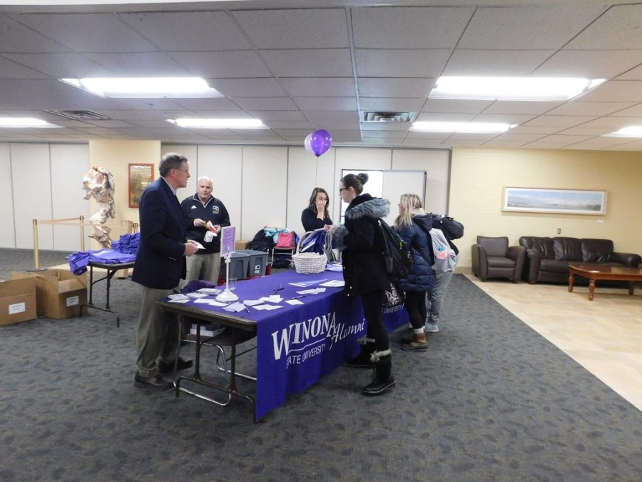Winona State alumni help graduating students get signed in and ready for graduation during the Warrior Graduate Celebration where students picked up honors cords and commencement tickets on Thursday, April 11 in East Room.