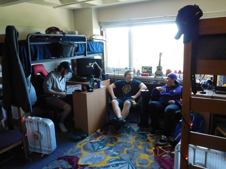 Left to right: Sophomore Zachary Stortz, first year Corbin Starr and Tyler Gliem sit in their dorm room in Sheehan Hall. This is the first year male students have been allowed to live in Sheehan in 50 years. 