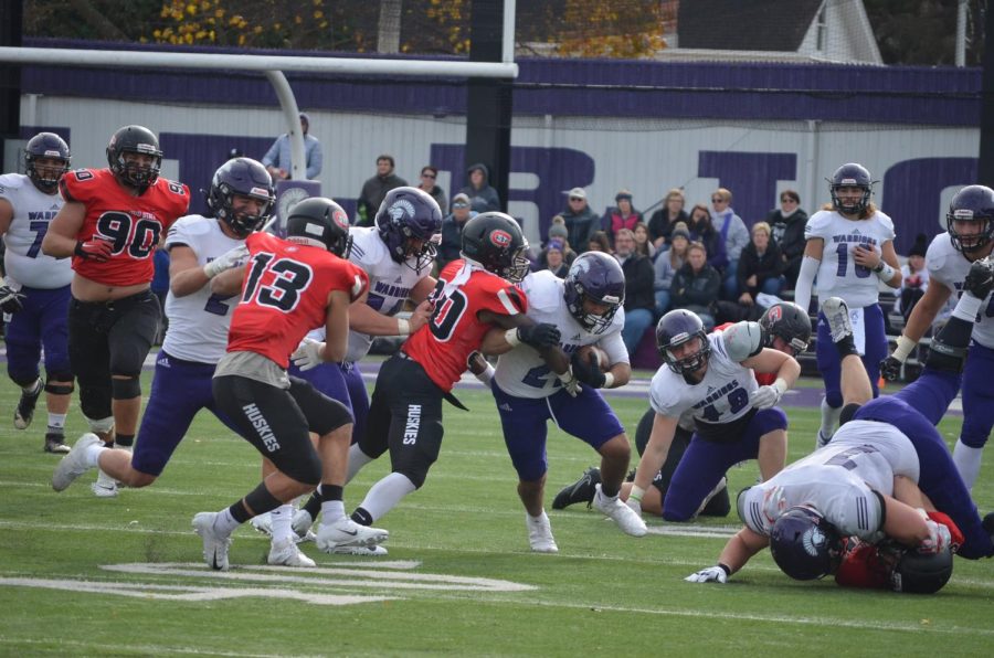 Sam Santiago-Lloyd, a junior running back, pushes through the defensive line against St. Cloud State University on Saturday, October 26 in Altra Federal Credit Union Stadium.  