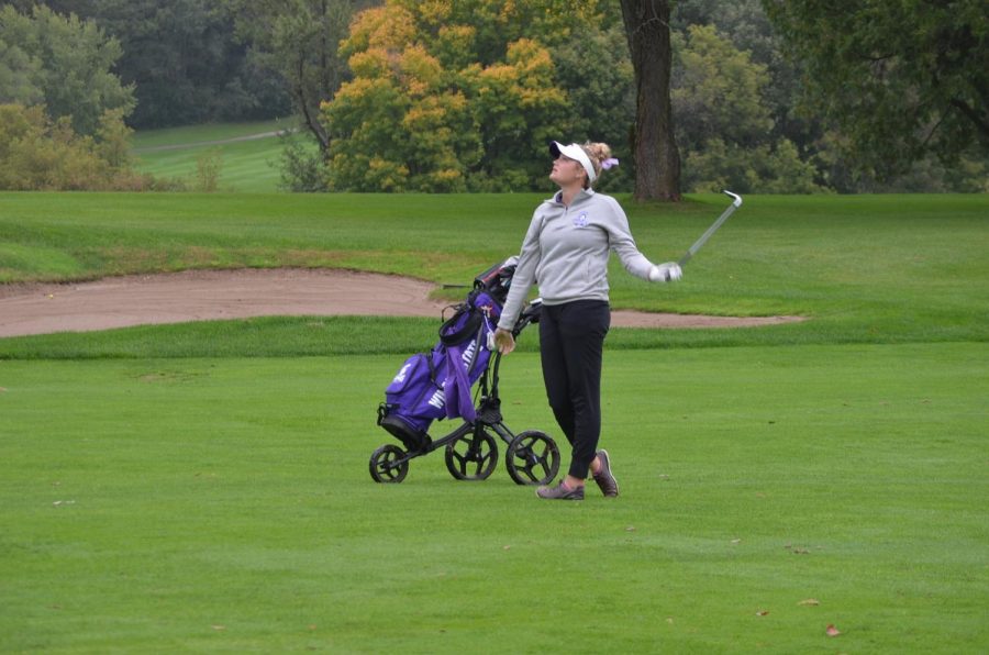 Sophomore Ally Loiselle watches for her ball during a duel against Viterbo University on Sunday, Sept. 29 at the Bridges Golf Course in Winona. The Warriors won with a team score of 321-334.