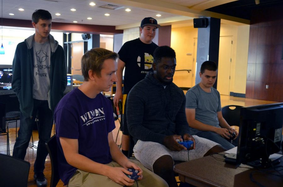 Club members watch as junior Trevor Firo and first-year Loic Boyogueno play Super Smash Bros. during a club tournament on Saturday, Sept. 28 in the Student Activities Center. 
