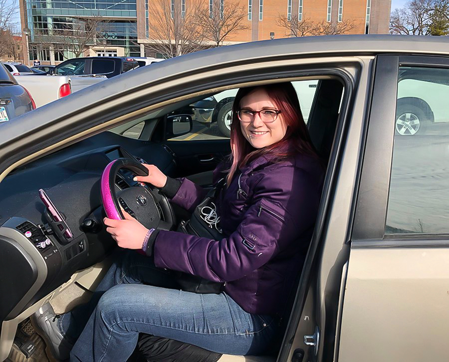 Lex Lea, a Winona State junior, poses in the driver’s seat of her Prius that has served as her vehicle of choice for the past six months as a Lyft driver. Winona didn’t have Lyft until 2018, a direct driver-to-rider, cashless car service controlled solely by cell phones.