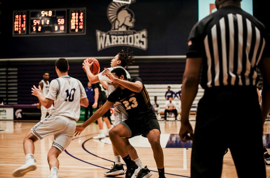 Winona State junior, Owen king attempts a shot for a 3-pointer against Wayne State, at the second game of the weekend on Saturday, Jan. 30. Warriors lost 84-78 against Wayne State
