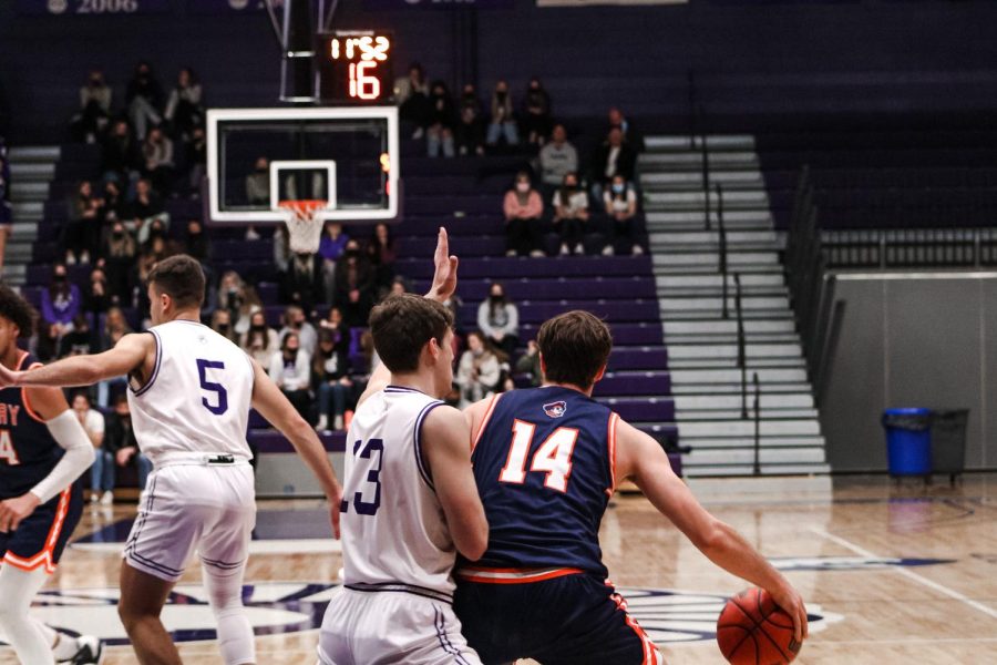 Carson Arenz (13) and Alec Rosner (5) blocking University of Mary’s Re- gan Tollefson and Kam Warrens. The final score on Friday, Feb. 2, was 80-67 for a Warrior win.