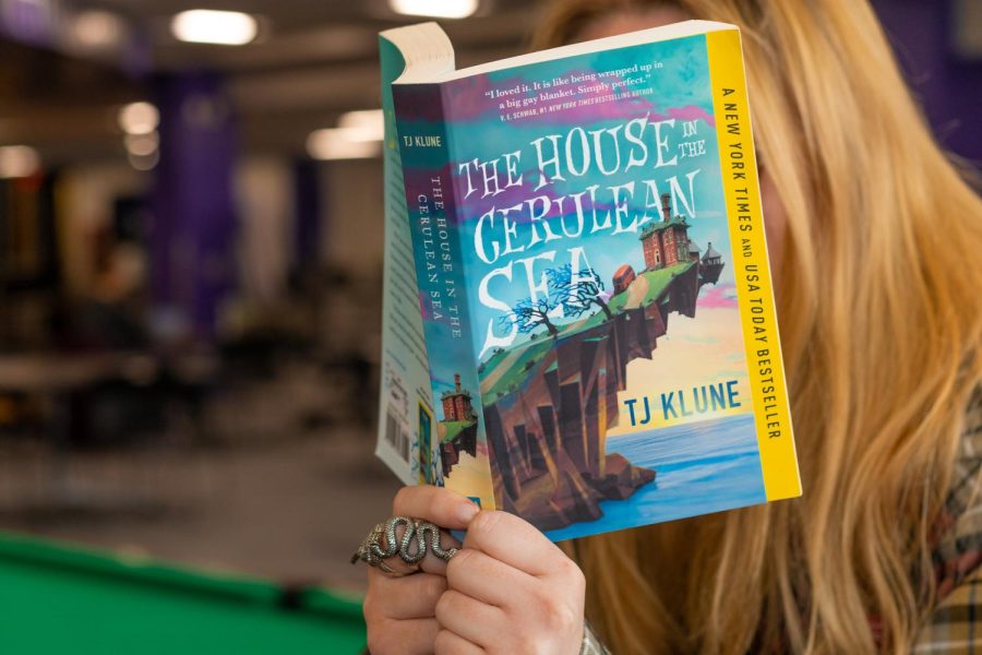 “The House in the Cerulean Sea” takes place in an alternate reality in which magic is real—but so are normal people, boring office jobs and soul-crushing nine-to-five shifts.