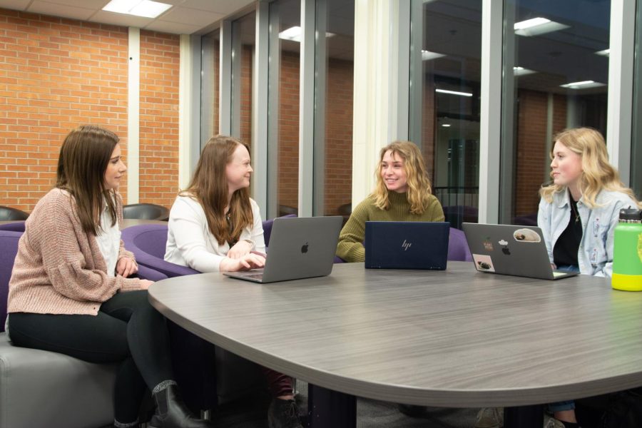 Taylor Kline, Madison Nelson, Kailee Johnson and Kaysey Price sit at a table in Kryzsko Commons. These graduate students worked together on an advocacy project for a marginalized group in their Foundations of Counseling class.